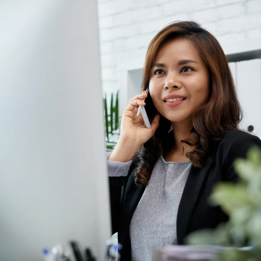 Offshore Filipino accountant taking a call at her desk